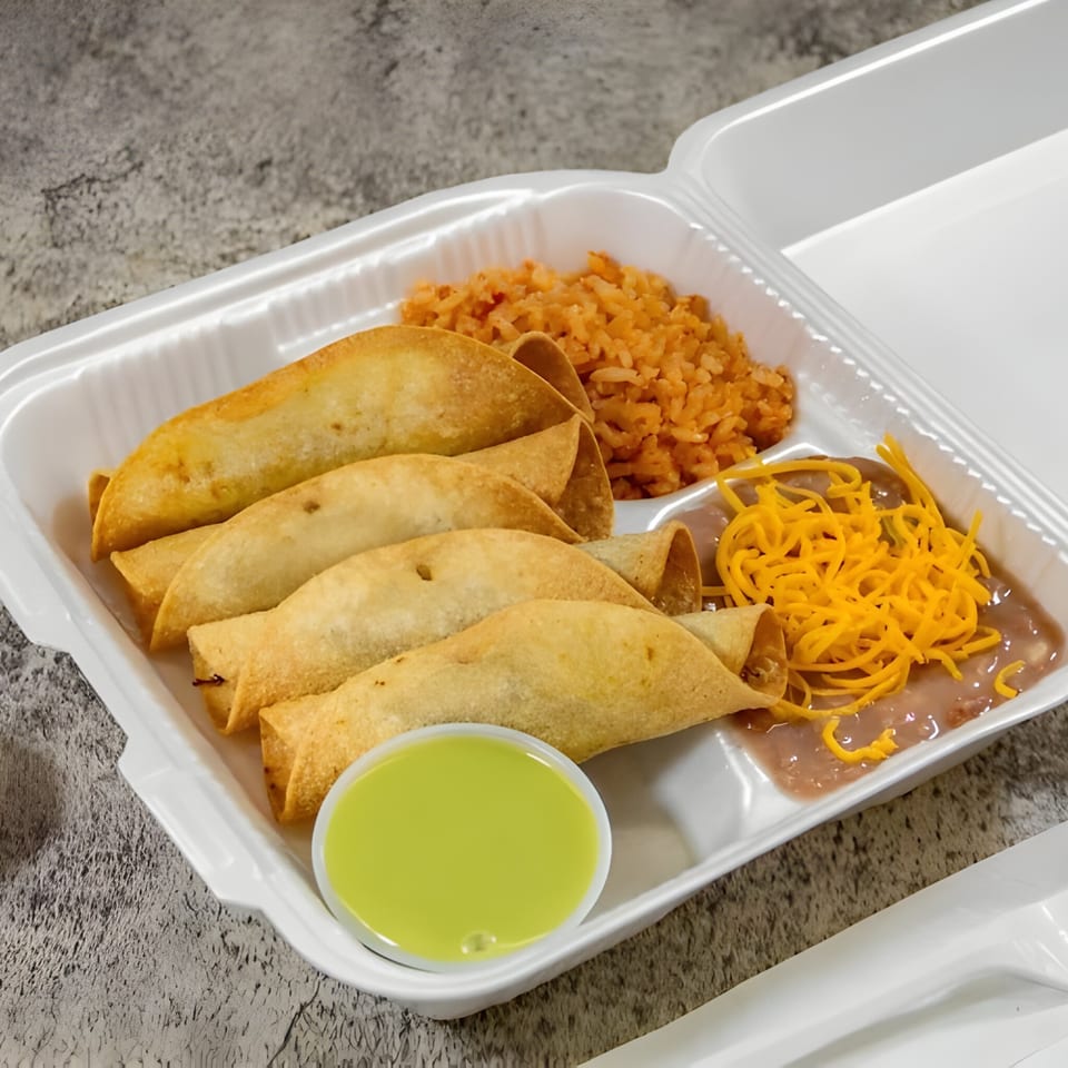 Juanitas III taquitos with rice, beans, shredded cheese, and green sauce in a takeout container.
